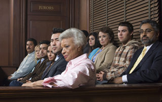 People at a trial on a jury.