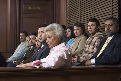 People at a trial on a jury.