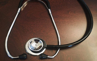 stethoscope on a wooden tabletop