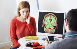 neurological injuries - woman looking at ct scan with doctor