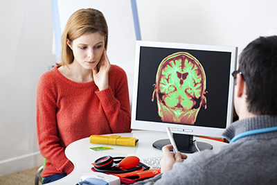 neurological injuries - woman looking at ct scan with doctor