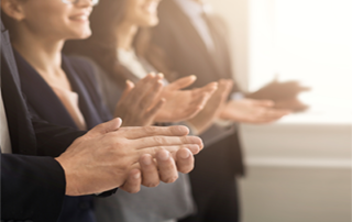 a group of people clapping their hands