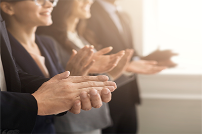 a group of people clapping their hands