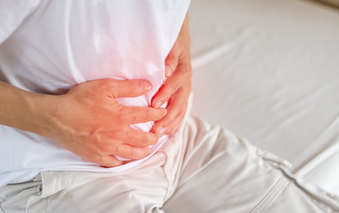 person holding stomach in pain
